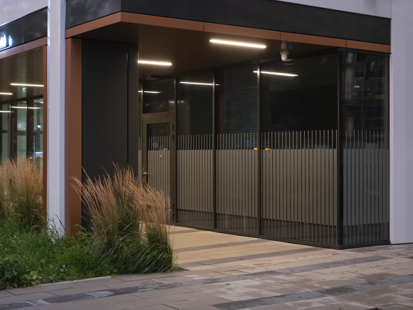 The full-height glass entrance to a modern office building